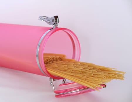 Pasta in Pink Glass Jar on a White 
Background.