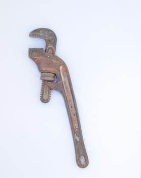 Old Rusty Adjustable Spanner On White 
Background.