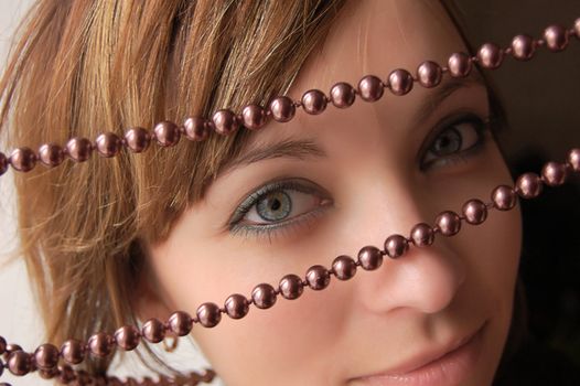 Brown-haired girl looking through pearl jewelery
