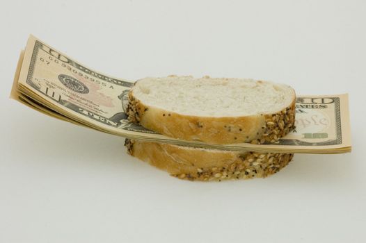 Sandwich with money, symbolising decrease in standard of living and inflation.