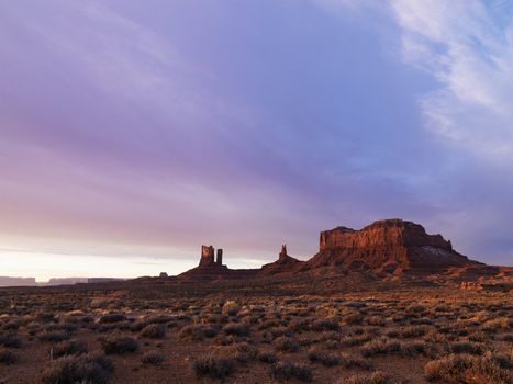 Scenic landscape at dusk of mesas in Monument Valley near the border of Arizona and Utah, United States.