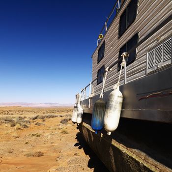 Landscape of houseboat sitting in the middle of the desert in rural Arizona, United States.