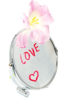 Love concept, words of love written on mirror with flower