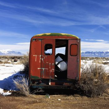 Landscape in rural snowy Colorado of open abandoned truck.