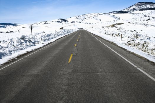 Perspective shot of road in snowy Colorado during winter.