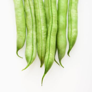 Close up of green beans on white background.