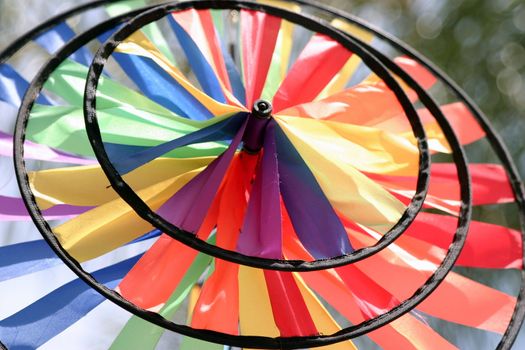 A round and colorful wind wheel made from fabric.