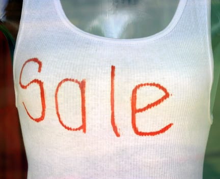 White undershirt with the text Sale written on it.