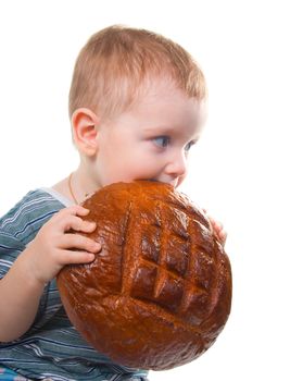 Small boy eating  a bread.big round loaf of bread of rustic bread .isolated