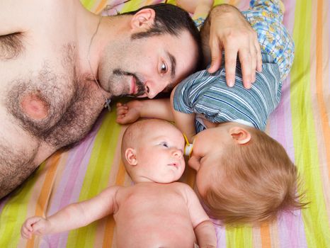 father and children repose .Newborn baby girl and small boy