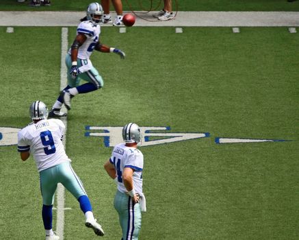 DALLAS - OCT 5: Taken in Texas Stadium in Irving, Texas on Sunday, October 5, 2008 during pregame warmup. Quarterback Tony Romo throws a pass to Marion Barber as backup QB Brad Johnson looks on.
