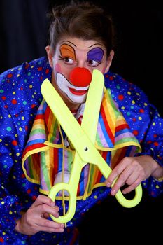 colorful clown with huge scissors