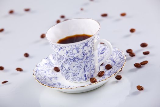 close up of a coffee cup with coffe beans