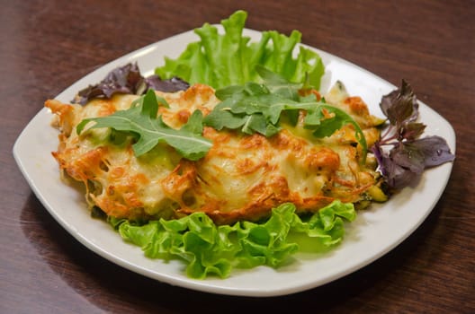 chicken fillet baked with zucchini, rucola lettuce