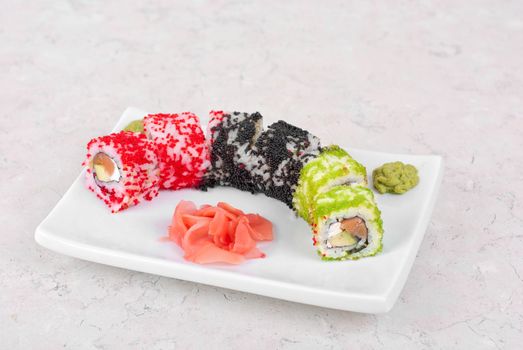 Sushi rolls made of salmon, avocado, flying fish roe - tobiko caviar and philadelphia cheese