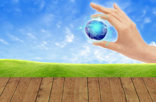 Eco concept : Hand hold globe  against   and the blue sky