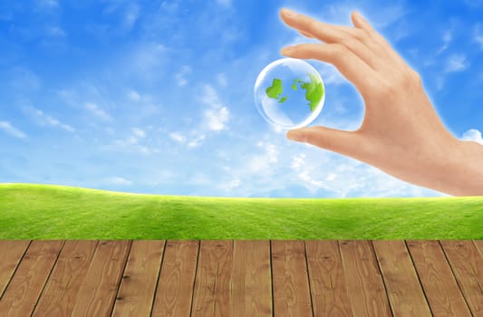 Eco concept : Hand hold globe  against   and the blue sky