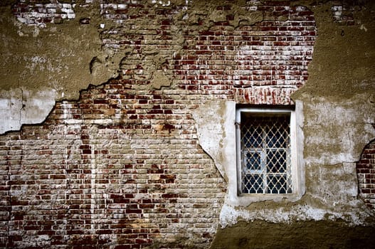 Wall in style grunge with a window in a curly grid