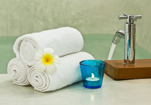 towel with frangipani on bathtub for relaxation