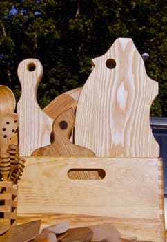 Wooden cuttung boards and wooden hand made tools used in the kitchen. Outdoor fair.