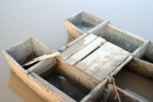 Double fishing boat at riverside