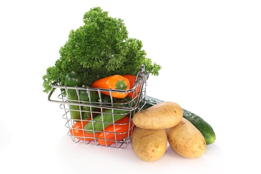 a shopping basket filled with colorful vegetables
