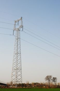 High voltage transmission lines with blue sky as background
