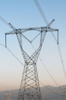 High voltage transmission lines with blue sky as background