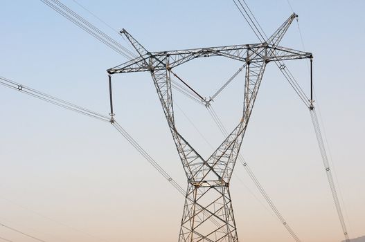 High voltage transmission lines with blue sky as background