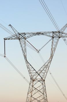 High voltage transmission lines with blue sky as background
