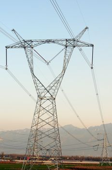 High voltage transmission lines with blue sky as background