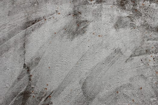 A fragment of metal sheet partially covered with white paint