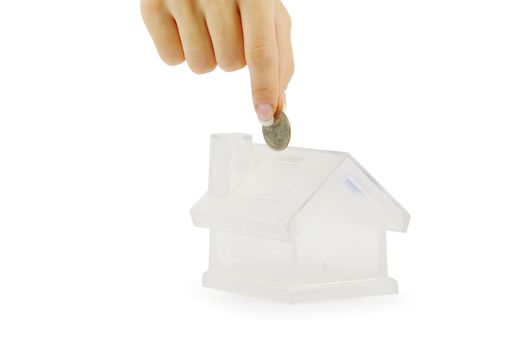 Hand with coin and house bank isolated on white background