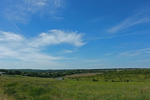 Beautiful skyscape over the village. The beginning of summer