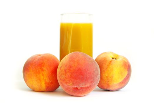 Glass with freshly made peach juice on a white background