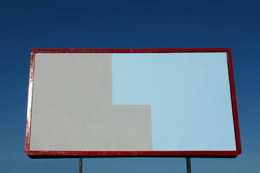 Empty big billboard on the background of blue sky 