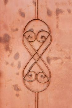 The decorative fragment of old rusty metal painted fence