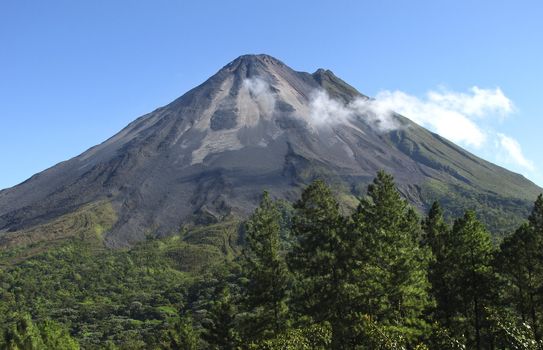Volcano Arenal in Costa Rica on a clear day. Smoke & steam coming out from just below the top cone. Northeastern slopes.