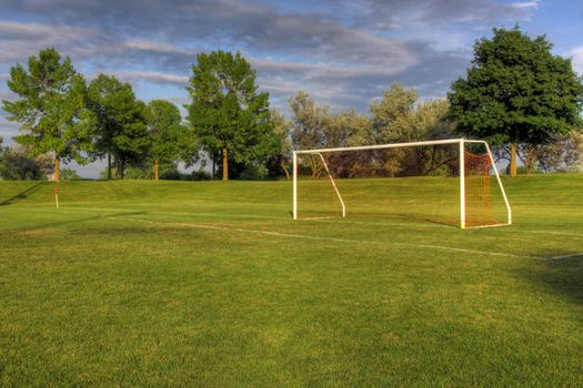 An empty soccer goal with trees in the background. (HDR photo)
