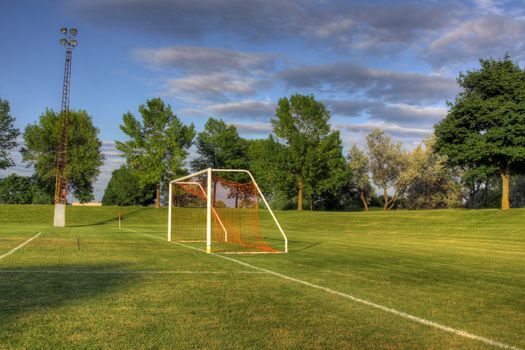 An empty soccer goal with trees in the background. (HDR photo)
