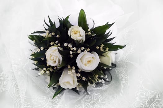 Wedding bouquet on a background of a veil