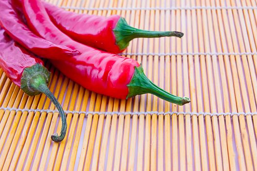 Red chilli peppers on wooden cloth