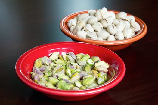 Two Bowls of Shelled and Unshelled Pistachio Nuts