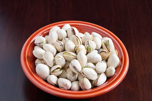 A bowl of Pistachios Nuts with Shell Macro Closeup