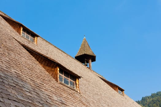 Roof detail of historical authentic architecture of old farm house in Black Forest, rural Germany