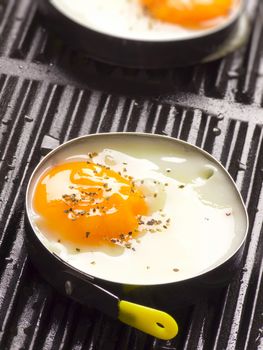 close up of fried eggs on a grill