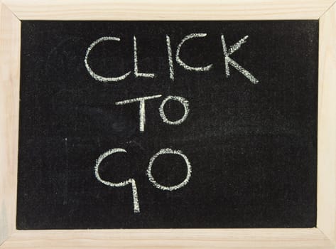 A black board with wooden frame and the hand written words in chalk 'click to go'.