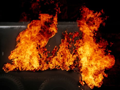 The back on a truck on fire with big flames