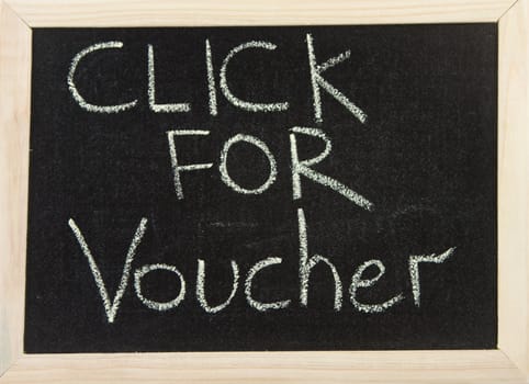 A black board with wooden frame and the hand written words in chalk 'click for voucher'.