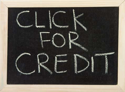 A black board with wooden frame and the hand written words in chalk 'click for credit'.